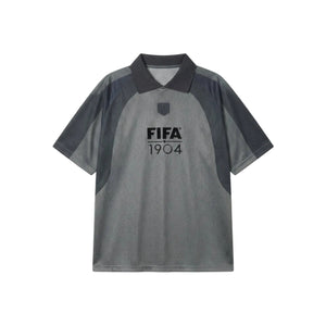 A short-sleeve polo shirt in heather gray and dark charcoal gray, featuring a 'FIFA 1904' logo printed on the chest, displayed flat against a light gray background.
